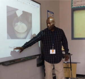 a teacher points at a page from a tar heel reader book